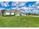 A well maintained single-story home with a two car garage and green lawn at 26052 Salonika Ln, Punta Gorda, FL 33983