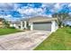 A well maintained single-story home with a two car garage and green lawn at 26052 Salonika Ln, Punta Gorda, FL 33983