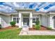 Inviting home entrance with manicured landscaping and a covered entryway at 26052 Salonika Ln, Punta Gorda, FL 33983