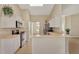 Modern kitchen features stainless steel appliances and sleek white cabinetry for ample storage at 26052 Salonika Ln, Punta Gorda, FL 33983