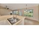 Bright kitchen features a stainless steel sink, neutral countertops, tile floors, and a view to the backyard at 26052 Salonika Ln, Punta Gorda, FL 33983