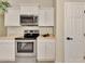 Modern kitchen with stainless steel range and ample storage is ideal for cooking enthusiasts at 26052 Salonika Ln, Punta Gorda, FL 33983