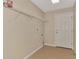 Practical laundry room with shelving, tiled floor and door at 26052 Salonika Ln, Punta Gorda, FL 33983