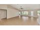 Spacious living room with lots of natural light, high ceiling, and seamless tile flooring at 26052 Salonika Ln, Punta Gorda, FL 33983