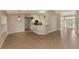Open-concept living space with views of the kitchen, and light tile throughout at 26052 Salonika Ln, Punta Gorda, FL 33983