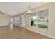 Spacious living room with tile floor and large windows overlooks the well-maintained lawn at 26052 Salonika Ln, Punta Gorda, FL 33983