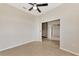 Open-concept living room featuring neutral paint, tile flooring, and a modern ceiling fan at 26052 Salonika Ln, Punta Gorda, FL 33983