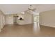 Expansive living room with seamless tile flooring leading to the kitchen and dining area at 26052 Salonika Ln, Punta Gorda, FL 33983