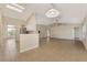 Open-concept living space with tile flooring connects kitchen to dining, ideal for entertaining at 26052 Salonika Ln, Punta Gorda, FL 33983