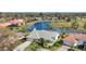 Stunning aerial view of a home with lush landscaping and a serene lake backdrop offering a peaceful neighborhood setting at 3445 Highlands Bridge Rd, Sarasota, FL 34235