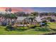 Landscaped backyard featuring a screened pool area, green lawn, and tall palm trees at 3445 Highlands Bridge Rd, Sarasota, FL 34235
