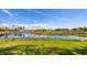 Scenic backyard view of the lake with lush green lawn at 3445 Highlands Bridge Rd, Sarasota, FL 34235