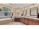 Bright bathroom with granite counters, wooden cabinets, and a large window over the tub at 3445 Highlands Bridge Rd, Sarasota, FL 34235