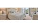 Cozy bedroom with neutral tones and a full-size bed, and glass doors to the backyard at 3445 Highlands Bridge Rd, Sarasota, FL 34235