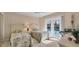 Bright bedroom with twin beds, sunny windows, and a calming view of the outdoor pool at 3445 Highlands Bridge Rd, Sarasota, FL 34235