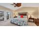 Bright bedroom with a ceiling fan, carpet, and large glass doors to the backyard at 3445 Highlands Bridge Rd, Sarasota, FL 34235