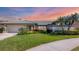 Charming home featuring lush landscaping, attached garage, and well manicured lawn at 3445 Highlands Bridge Rd, Sarasota, FL 34235