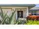 Inviting front entrance with a black front door, side lights, and well manicured landscape at 3445 Highlands Bridge Rd, Sarasota, FL 34235