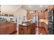 Modern kitchen with an island, stainless steel appliances, and hardwood floors at 3445 Highlands Bridge Rd, Sarasota, FL 34235
