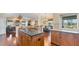 Spacious kitchen with granite countertops, custom cabinets, island, and hardwood flooring at 3445 Highlands Bridge Rd, Sarasota, FL 34235