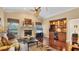 Cozy living room with a fireplace, built-in bar area, and hardwood floors at 3445 Highlands Bridge Rd, Sarasota, FL 34235