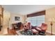 Bright, carpeted office with desk, two leather chairs and large window at 3445 Highlands Bridge Rd, Sarasota, FL 34235