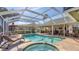Relaxing pool area with spa and lounge chairs, surrounded by lush greenery at 3445 Highlands Bridge Rd, Sarasota, FL 34235