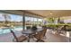 Screened-in patio with a pool, lush greenery, and outdoor seating area at 3445 Highlands Bridge Rd, Sarasota, FL 34235