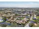 Expansive aerial shot showcasing a villa community, complemented by lush landscaping, tranquil ponds, and neighborhood streets at 3522 57Th Avenue W Cir, Bradenton, FL 34210