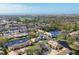 Picturesque aerial shot showcasing a villa community with ponds, trees, and a golf course in the distance at 3522 57Th Avenue W Cir, Bradenton, FL 34210