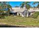 Back exterior view of home showing lush landscaping and peaceful surroundings at 3522 57Th Avenue W Cir, Bradenton, FL 34210