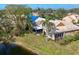 Villa featuring a screened lanai, complemented by tropical palm trees, a pond, and an inviting backyard at 3522 57Th Avenue W Cir, Bradenton, FL 34210