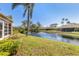 Landscaped backyard with pond views, fountain feature and verdant lawn at 3522 57Th Avenue W Cir, Bradenton, FL 34210
