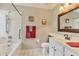 Bright bathroom featuring a tub and shower combination with white tile floors and a white vanity at 3522 57Th Avenue W Cir, Bradenton, FL 34210
