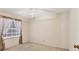 Clean and well-lit bedroom with plush carpet, a window with decorative curtains and neutral walls at 3522 57Th Avenue W Cir, Bradenton, FL 34210