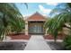 Inviting clubhouse entrance, featuring a covered entry and decorative accents, surrounded by manicured landscaping and palm trees at 3522 57Th Avenue W Cir, Bradenton, FL 34210