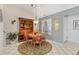 Dining area with a round table, wooden hutch, and a view of the backyard at 3522 57Th Avenue W Cir, Bradenton, FL 34210