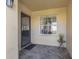 Welcoming front porch with tiled floor, security screen door and a decorative side table at 3522 57Th Avenue W Cir, Bradenton, FL 34210