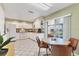 Spacious kitchen and breakfast nook with white cabinets, white appliances and access to a patio at 3522 57Th Avenue W Cir, Bradenton, FL 34210