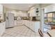 Well-lit kitchen with white cabinets, stainless steel appliances, and easy access to the patio at 3522 57Th Avenue W Cir, Bradenton, FL 34210