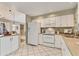 Bright kitchen with ample counter space, white cabinets, and an open view to the breakfast nook at 3522 57Th Avenue W Cir, Bradenton, FL 34210