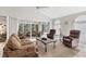 Bright living room featuring large windows and sliding glass doors to the outdoor patio at 3522 57Th Avenue W Cir, Bradenton, FL 34210
