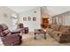 Open living room featuring a sofa, two recliners, and seamless access to the dining area at 3522 57Th Avenue W Cir, Bradenton, FL 34210