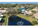 Scenic aerial view highlighting a peaceful pond with a fountain and lush landscaping of the villa community at 3522 57Th Avenue W Cir, Bradenton, FL 34210