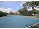 Well-maintained tennis court surrounded by lush greenery and trees, offering a serene recreational setting at 3522 57Th Avenue W Cir, Bradenton, FL 34210