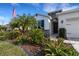 Lovely home featuring a dark front door and lush landscaping and greenery at 4034 Mossy Limb Ct, Palmetto, FL 34221