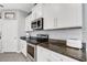 Well-lit kitchen featuring stainless appliances, white cabinets, and granite countertops at 4034 Mossy Limb Ct, Palmetto, FL 34221