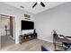 Neutral living room featuring a ceiling fan, a TV and a wooden console at 4034 Mossy Limb Ct, Palmetto, FL 34221