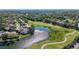 Stunning aerial view showcasing home's location with lake and golf course views at 4060 Penshurst Park, Sarasota, FL 34235