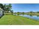 Lush backyard with pond offering serene views and plenty of green space at 4060 Penshurst Park, Sarasota, FL 34235